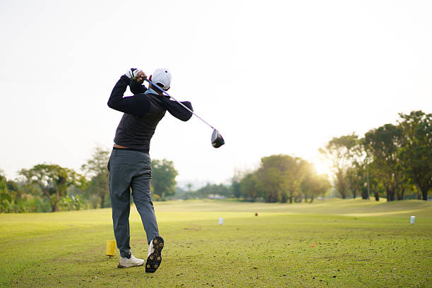 istock Golfer performing a powerful tee off swing on bright scenic fairway. 2249111768