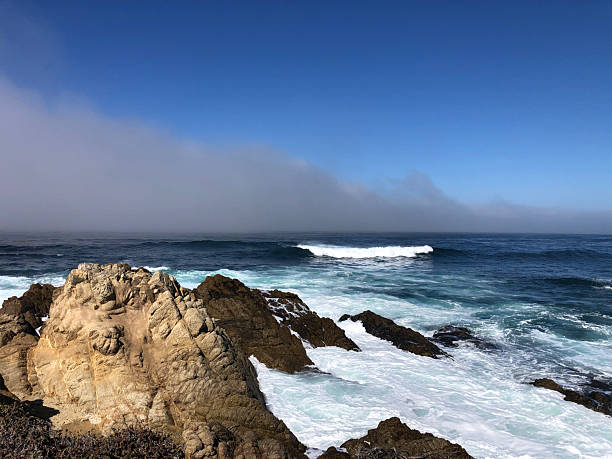istock Waves Crashing Against Rugged Cliffs Under a Clear Blue Sky at a Serene Coastal Location 2249113785