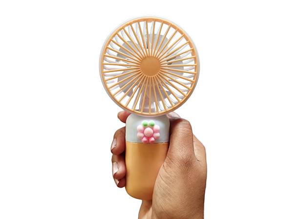 istock Hand holding small portable cooling fan 2249115450