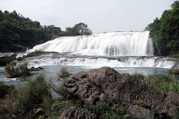 View of the Doupotang Waterfall. It is a 105-meter-wide and 21-meter-high waterfall in Huangguoshu Waterfall Scenic Area, Guizhou, China. The top of the waterfall is the widest among all of the Huangguoshu waterfalls.