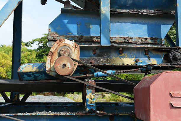 Capture the essence of enduring industrial design with this detailed machinery scene, featuring aged textures and striking blue hues in a captivating outdoor setting.