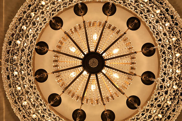 istock Ornate crystal chandelier with multiple light bulbs 2249119741