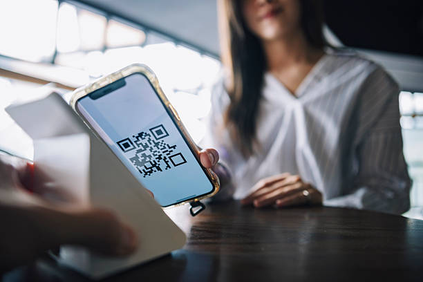 istock A young Asian woman uses her smartphone for mobile payment by scanning a QR code at a cafe, reflecting modern digital finance and cashless lifestyle 2249120230