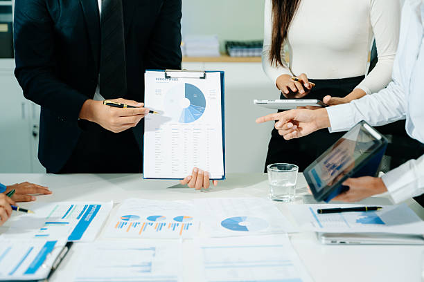 istock Businessman and team analyzing financial statement Finance task. with smart phone and laptop and  tablet. 2249124098