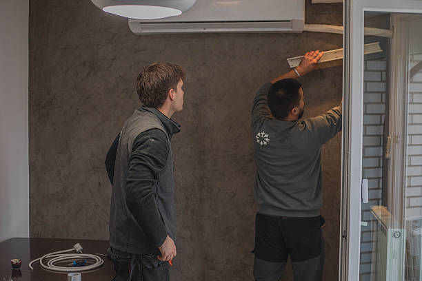 istock Installing an air conditioner, two young craftsmen 2249124230