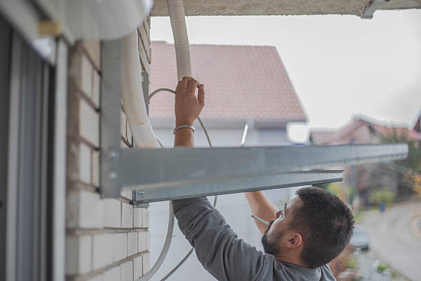 istock A handyman installs an air conditioner and smokes a cigar. 2249124236