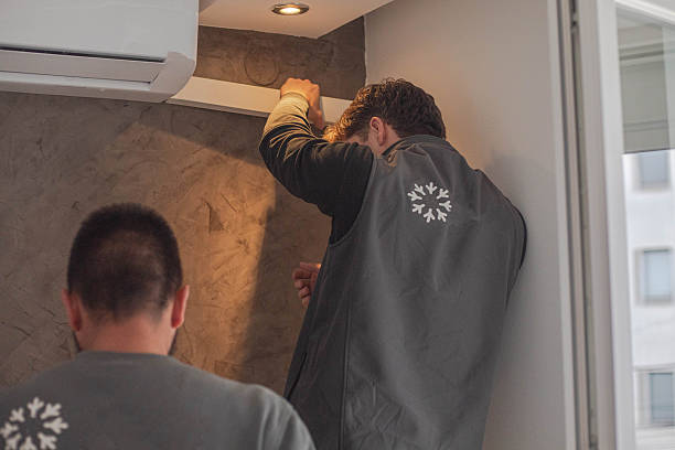 istock Installing an air conditioner, two young craftsmen 2249124254