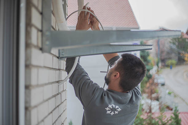 istock A handyman installs an air conditioner and smokes a cigar. 2249124256