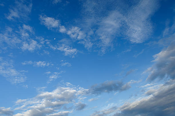 Half moon in the night sky in winter, featuring beautiful cloudscape