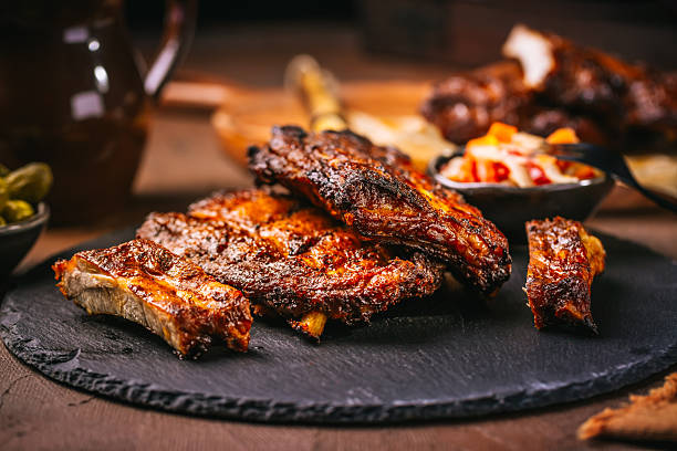 istock Delicious spare ribs with pickles on cutting board 2249128921