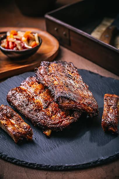istock Delicious spare ribs with pickles on cutting board 2249128923