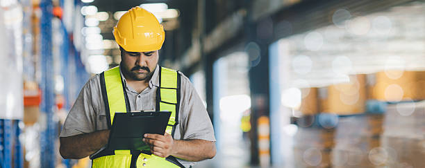 istock Warehouse worker working in warehouse storage. Foreman or worker work at factory site check up products in site. Inventory worker working in  factory Storehouse 2249130917