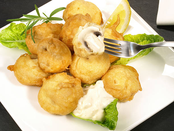 Fried Champignon Mushrooms with Garlic Sauce on a Plate