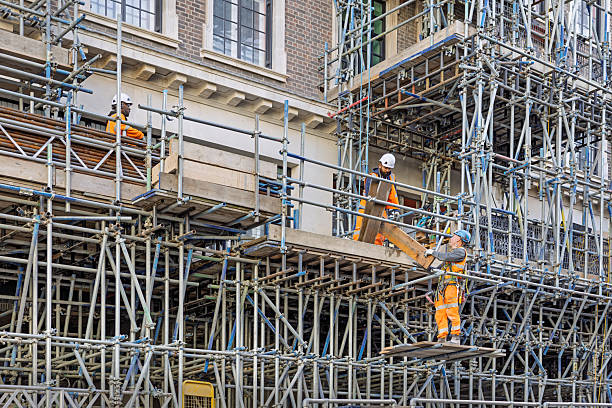 Shaftebury Avenue, London, England, United Kingdom, Europe - November 1st 2025: Group of construction workers renovating an old house on scaffolding in the historic city center of London, United Kingdom.