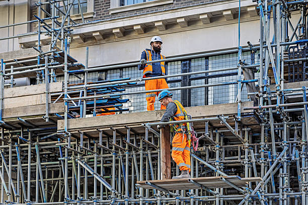 Shaftebury Avenue, London, England, United Kingdom, Europe - November 1st 2025: Group of construction workers renovating an old house on scaffolding in the historic city center of London, United Kingdom.