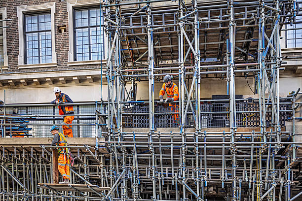 Shaftebury Avenue, London, England, United Kingdom, Europe - November 1st 2025: Group of construction workers renovating an old house on scaffolding in the historic city center of London, United Kingdom.