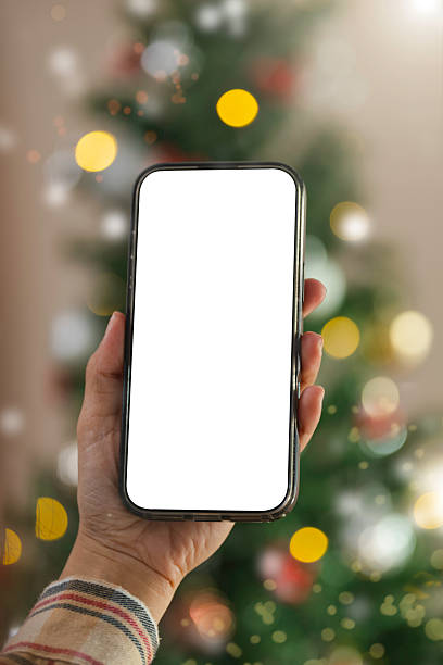 istock Smartphone screen mockup in hand showcased against festive Christmas lights to emphasize digital holiday marketing mobile app promotion and seasonal online engagement 2249135500