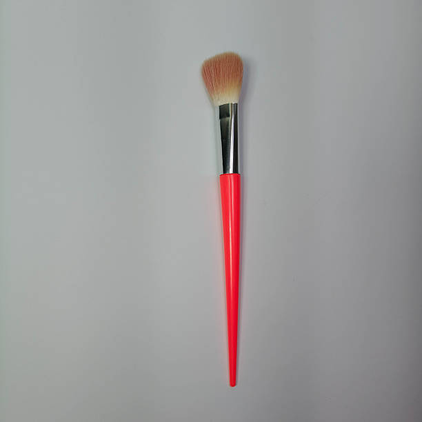 istock Elegant powder brush designed for makeup application showcased on a clean white surface, suitable for beauty advertising and cosmetic accessory themes. 2249135554