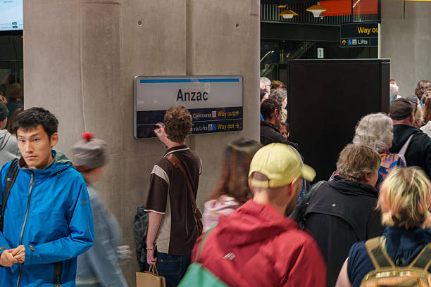 Melbourne, VIC, Australia. November 30, 2025. - A diverse crowd of visitors and passengers navigate the bustling Anzac Station concourse on the Metro Tunnel's opening day.