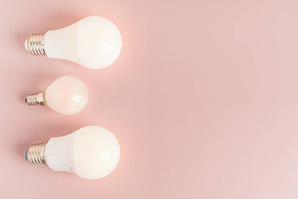 istock Assortment of led light bulbs lamps on pastel brown background with copy space 2249137078