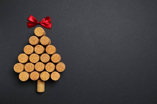 istock Christmas tree shaped wine corks on black background. Top view with copy space for text 2249139776