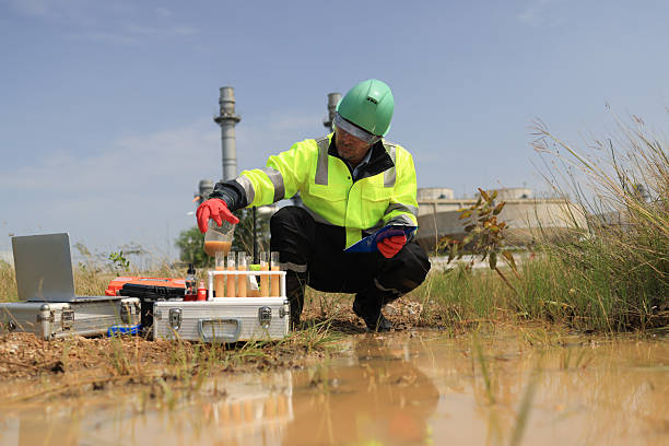 istock An environmental engineer wearing green safety gear is sampling and testing water around the factory 2249141920