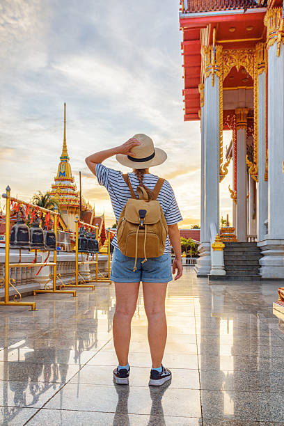 istock Female tourist in hat with backpack at a Buddhist temple 2249141990