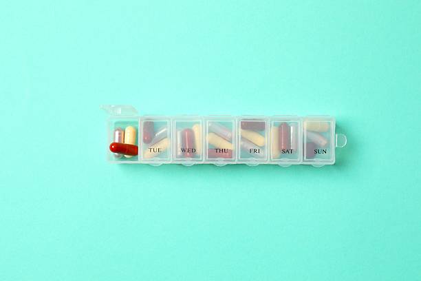 istock Daily pill box with medications on color background, top view 2249143480