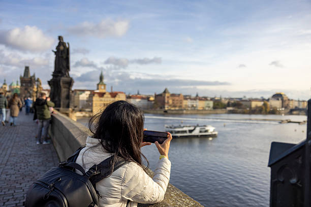 istock Woman Taking A Landscape Photo From Charles Bridge 2249145158