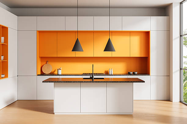 istock Modern kitchen interior with orange and white cabinets, pendant lighting, central island, and minimalist design in daylight environment. 3D Rendering 2249145227