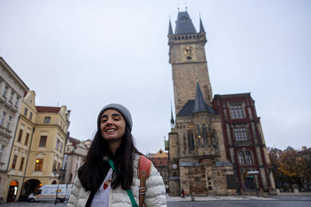 woman posing in front of the  Astronomical Clock Tower