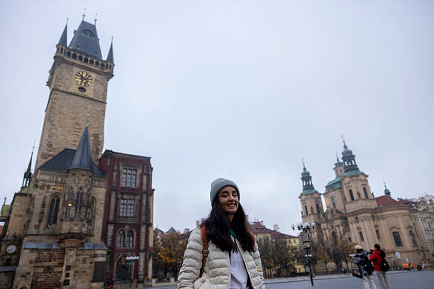 woman posing in front of the  Astronomical Clock Tower