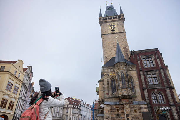 woman taking photos of Astronomical Clock Tower
