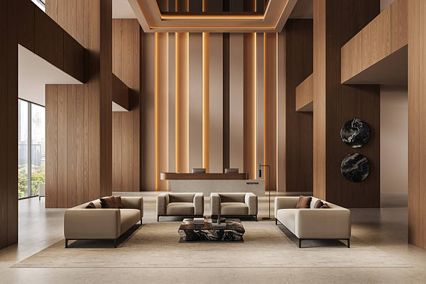 Stylish hotel lobby interior with modern furniture, warm wood panel accents, ambient lighting on vertical walls, and neutral color palette. 3D Rendering