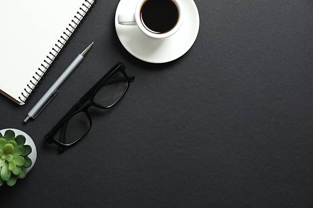 istock Office table with notebook, stationery, glasses and cup of coffee, top view 2249146534