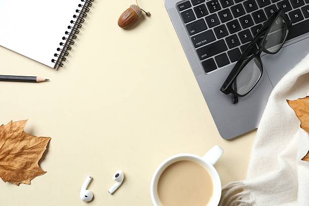 istock Workplace with notebook, laptop, glasses and coffee cup, top view 2249146758