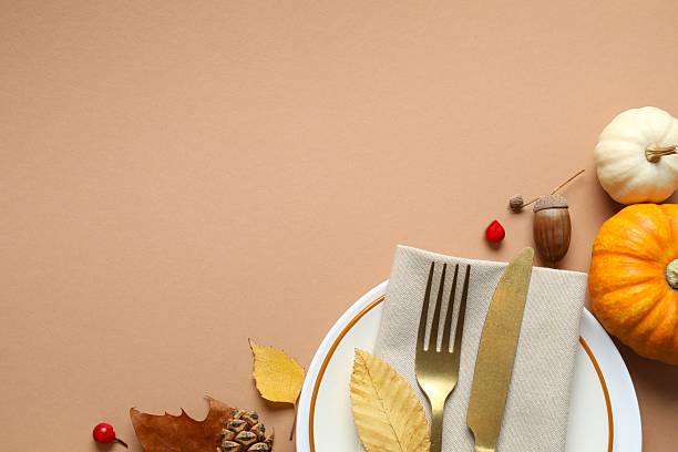 istock Thanksgiving day. Close-up of table setting with pumpkins, dinnerware, rustic napkin on a plates 2249147533