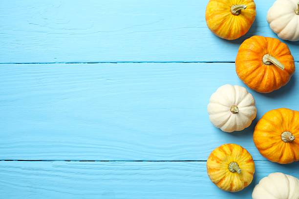 istock Beautiful autumn composition with pumpkins on a wooden background, top view 2249147715