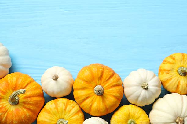 istock Beautiful autumn composition with pumpkins on a wooden background, top view 2249147717