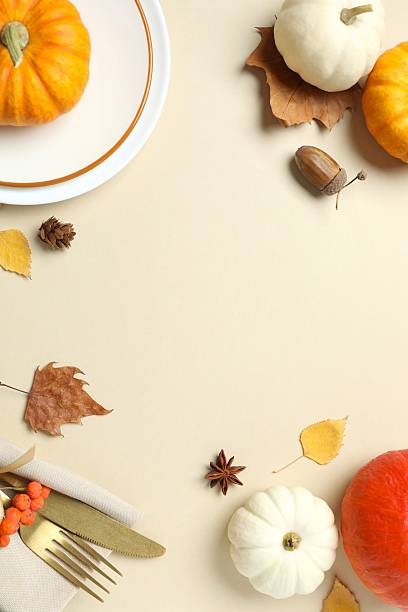 istock Close-up of table setting with pumpkins, dinnerware, rustic napkin on a plates. Thanksgiving day 2249147856