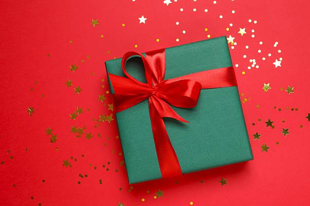 istock Beautiful gift box with golden confetti on color background 2249149399