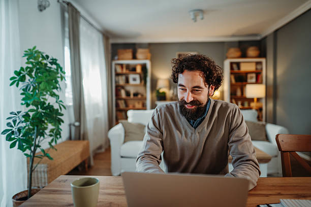 istock Man smiling working on laptop from home office 2249156491