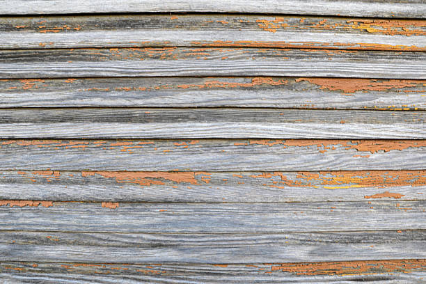 A Weathered Wooden Boards Texture Featuring Aged Grain Patterns, Faded Colors, And Peeling Orange Paint, Providing A Rustic And Vintage Look Ideal For Backgrounds, Design Projects, And Architectural Themes.