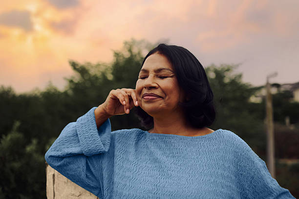 istock Middle Aged Woman Recharging Outdoors Relaxing Peacefully At Sunset 2249159069