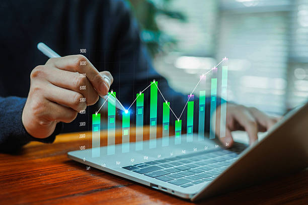 istock A person analyzing a digital bar and line chart on a laptop, highlighting monthly growth, financial performance, data analytics, and business strategy for investment and economic planning concepts. 2249161029