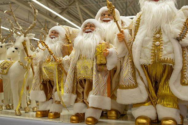 Christmas holiday decor. Decorative Santa Claus figurines on store counter