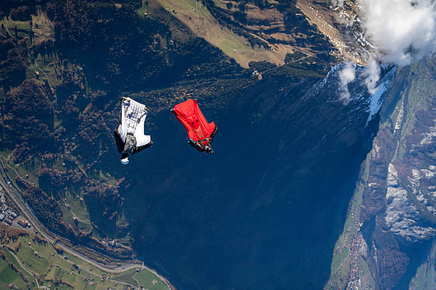 istock Wingsuit fliers fly side by side over snowcapped mountains 2249167495