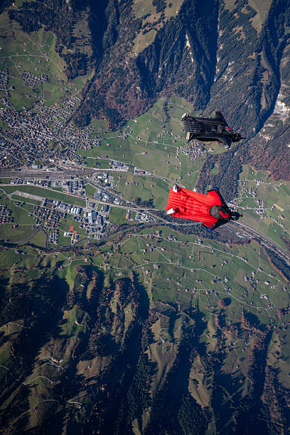 istock Wingsuit fliers fly side by side over snowcapped mountains 2249167496