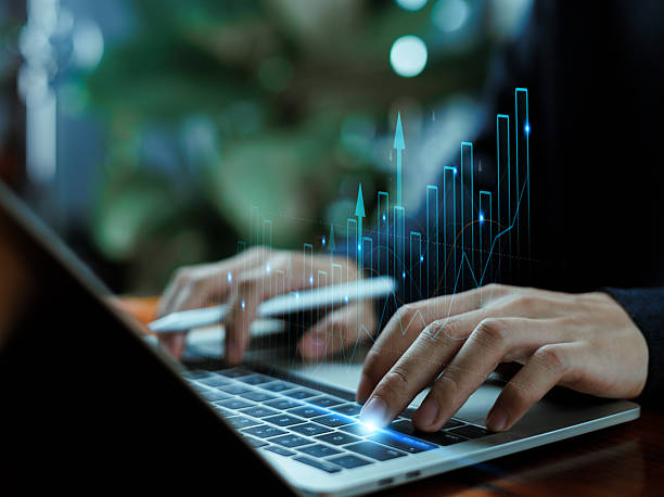 istock Hands typing on a laptop with rising digital charts and glowing analytics, symbolizing financial growth, data analysis, market trends, business performance, and modern technology. 2249167552