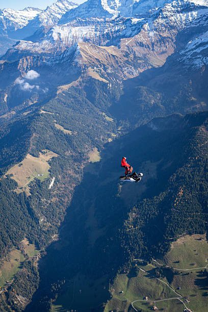 istock Wingsuit fliers fly side by side over snowcapped mountains 2249167571